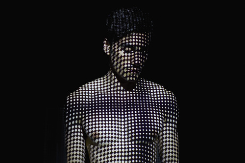 Young man Covered by Abstract Patterns of Light